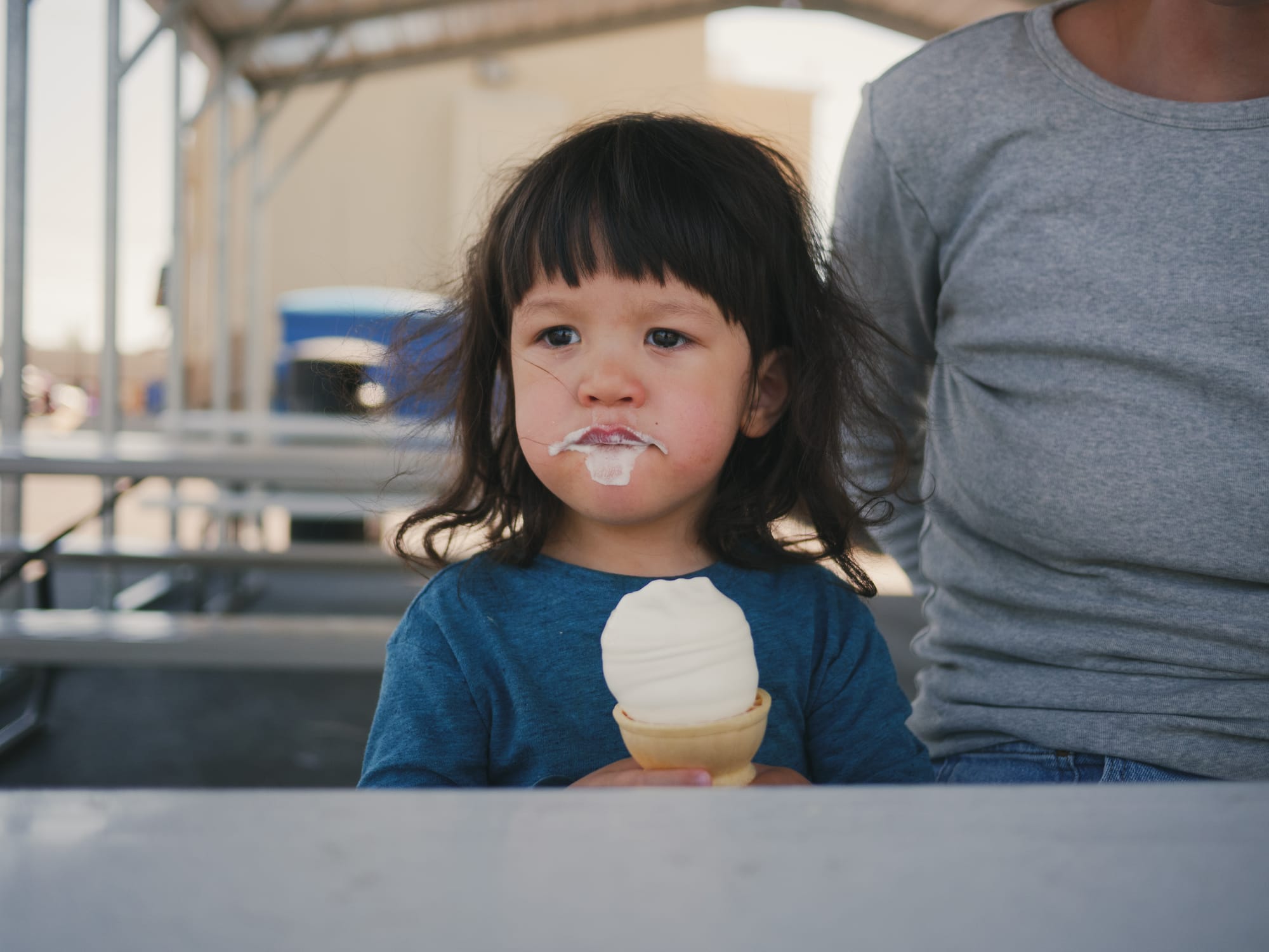 Rufus holding an ice cream cone with a musketeerian ice cream mustache.